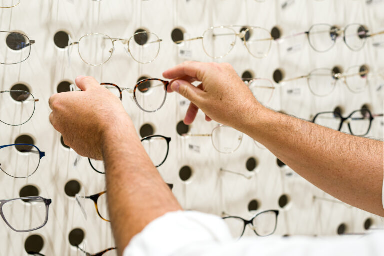 Different eyeglasses on the wall in the eyewear shop