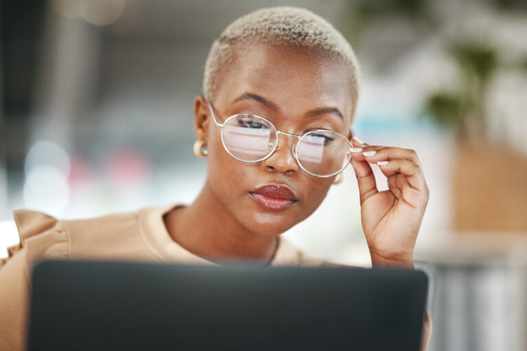 Office, laptop and black woman, reflection in glasses and thinking, checking email or search on dig